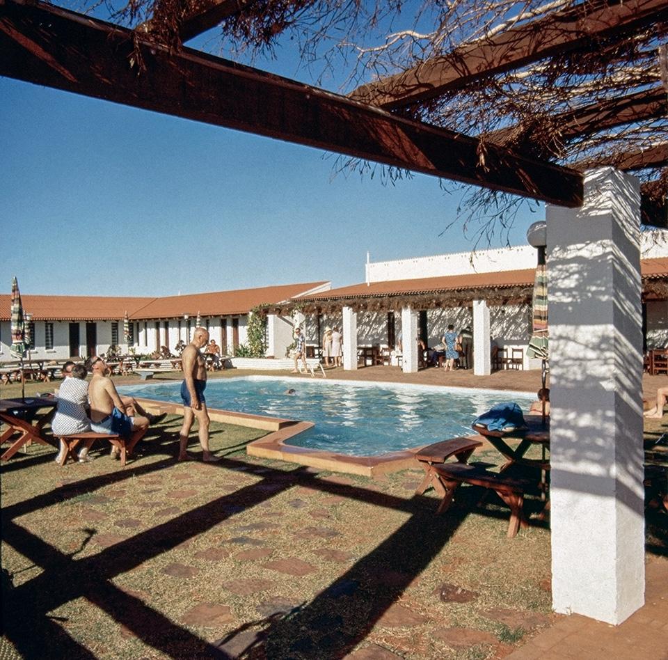 Old photo of people at a motel pool